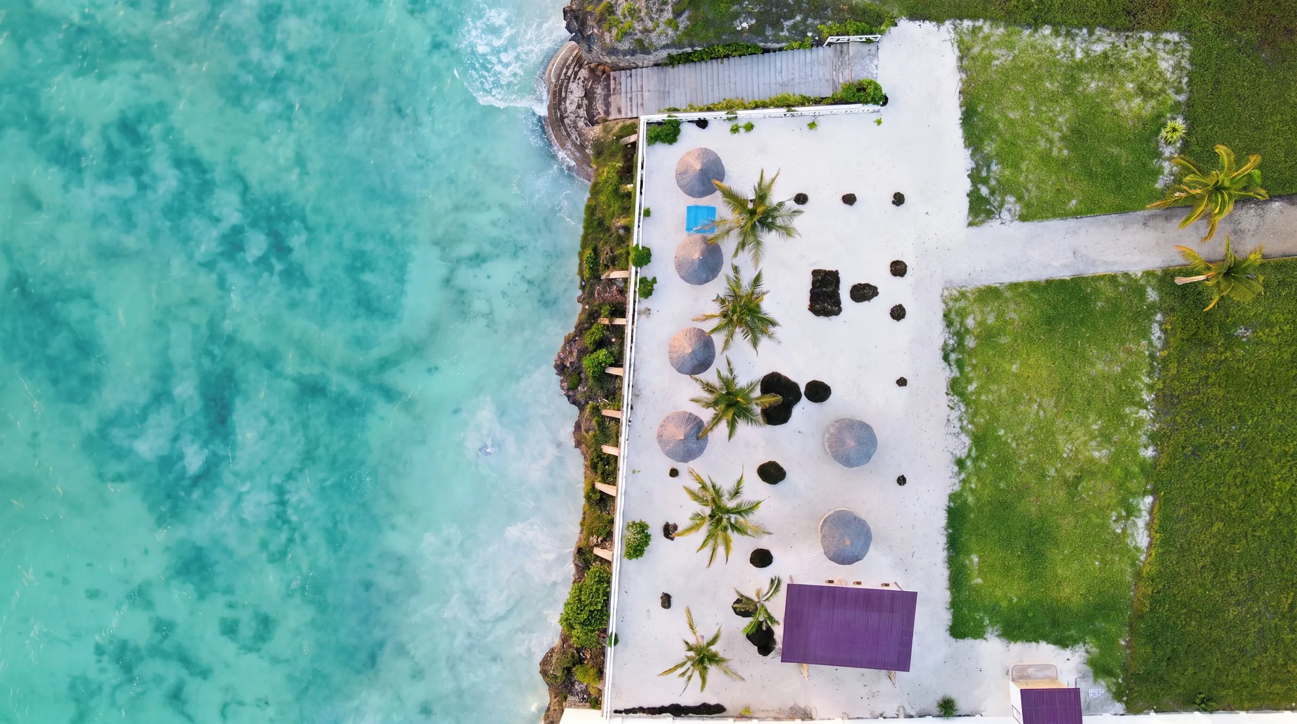 Aerial of Raffia Boutique Hotel where the property meets the turquoise sea, Jambiani